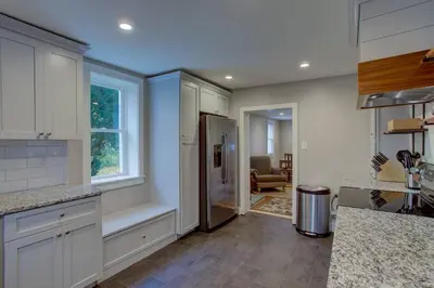 a kitchen with a refrigerator and a window at Calla Lily Farmhouse in Manheim