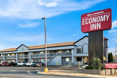 a sign for an economy inn in a parking lot at Bellmawr Economy Inn Bellmawr-Philadelphia Area in Bellmawr