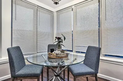 a dining room with a glass table and two chairs at Pet-Friendly Newark Townhome Near Airport! in Newark