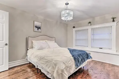 a bedroom with a large bed and a window at Pet-Friendly Newark Townhome Near Airport! in Newark