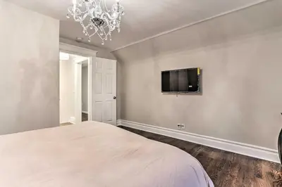 a bedroom with a bed and a tv on the wall at Pet-Friendly Newark Townhome Near Airport! in Newark