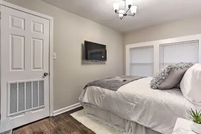 a bedroom with a bed and a flat screen tv at Pet-Friendly Newark Townhome Near Airport! in Newark