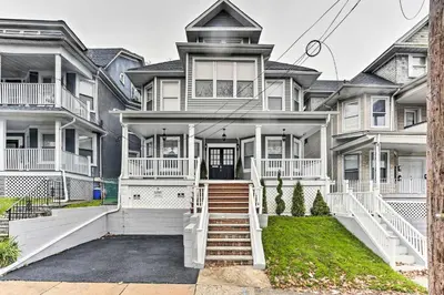 a large house with white trim at Pet-Friendly Newark Townhome Near Airport! in Newark