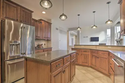 a kitchen with wooden cabinets and a stainless steel refrigerator at Pool and Furnished Patio Group Getaway in Hershey in Hershey