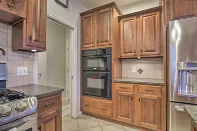a kitchen with wooden cabinets and a stove top oven at Pool and Furnished Patio Group Getaway in Hershey in Hershey