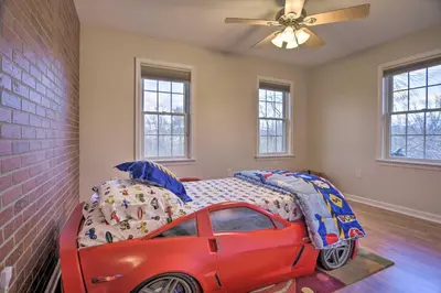 a red car bed in a room with windows at Pool and Furnished Patio Group Getaway in Hershey in Hershey