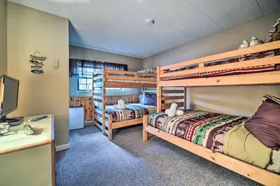a bedroom with two bunk beds and a desk at Steps to Shore Scenic Big Boulder Lake Condo! in Lake Harmony