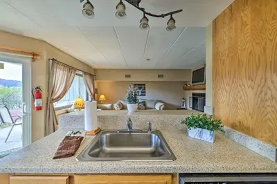 a kitchen with a stainless steel sink in a caravan at Steps to Shore Scenic Big Boulder Lake Condo! in Lake Harmony