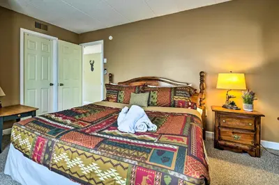 a bedroom with a bed with a towel on it at Steps to Shore Scenic Big Boulder Lake Condo! in Lake Harmony