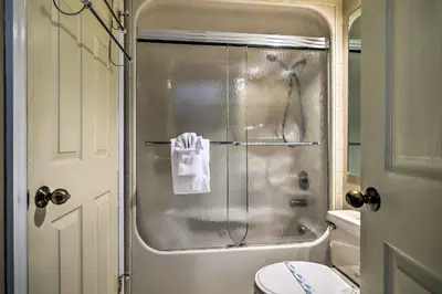 a bathroom with a shower with a toilet and a sink at Steps to Shore Scenic Big Boulder Lake Condo! in Lake Harmony