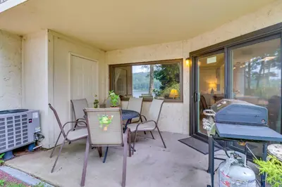 a patio with a table and chairs and a grill at Steps to Shore Scenic Big Boulder Lake Condo! in Lake Harmony