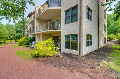 an apartment building with a pathway in front of it at Steps to Shore Scenic Big Boulder Lake Condo! in Lake Harmony
