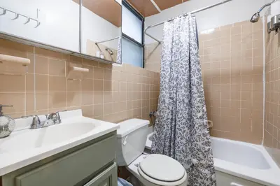 a bathroom with a sink and a toilet and a shower at Park Side Living, Get Cozy! in New York