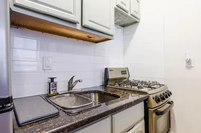 a kitchen with a sink and a stove at Park Side Living, Get Cozy! in New York