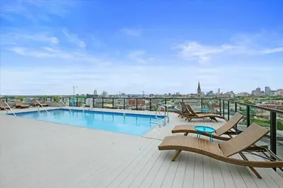 a swimming pool on the roof of a building at XL Studio - Studio with Pool & Scenic Rooftop in Philadelphia
