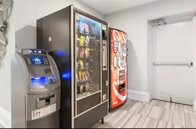 a video game machine next to a video game console at XL Studio - Studio with Pool & Scenic Rooftop in Philadelphia