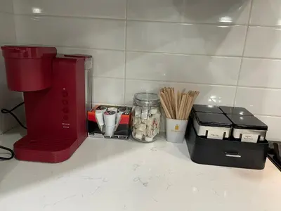 a kitchen counter with a red coffee maker and utensils at Modern Luxury Apartment near NYC in Jersey City