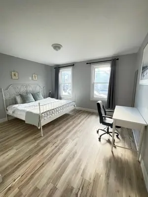 a bedroom with a bed and a desk and a chair at Modern Luxury Apartment near NYC in Jersey City