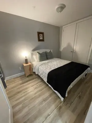 a bedroom with a bed and a wooden floor at Modern Luxury Apartment near NYC in Jersey City