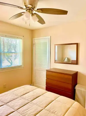 a bedroom with a bed and a ceiling fan at Scenic Views & River Access, Cozy River Home in Montague