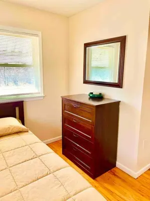 a bedroom with a bed and a dresser and a mirror at Scenic Views & River Access, Cozy River Home in Montague