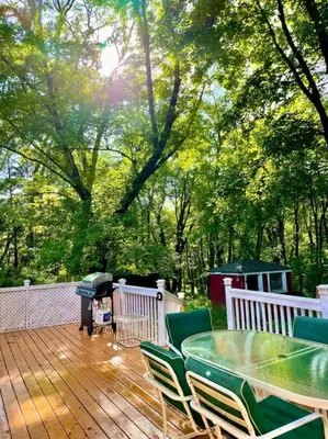 a deck with a table and chairs and a grill at Forest and River Side Tranquil House in Montague