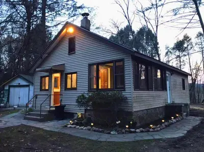 a small house with a light on top of it at Rare River Views & Access, Cabin by Eden Islands in Montague