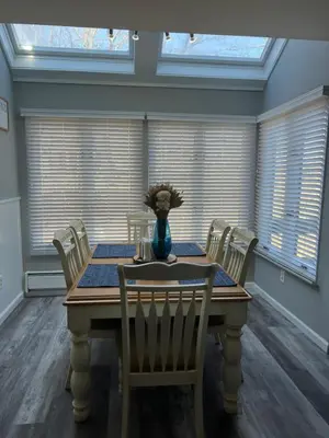 a dining room table with chairs and a vase of flowers on it at Modern 3BR Townhouse Near Kalahari, Aquatopia & Great Wolf in Tannersville