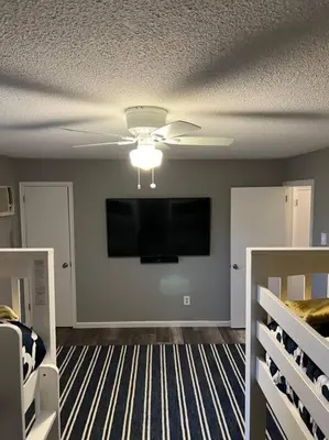 a living room with a flat screen tv on the wall at Modern 3BR Townhouse Near Kalahari, Aquatopia & Great Wolf in Tannersville