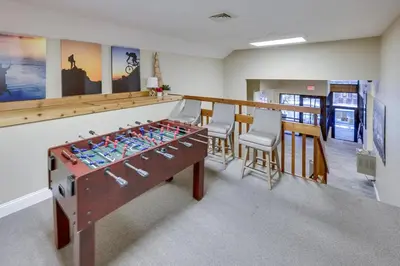 a room with a ping pong table and chairs at Modern 3BR Townhouse Near Kalahari, Aquatopia & Great Wolf in Tannersville