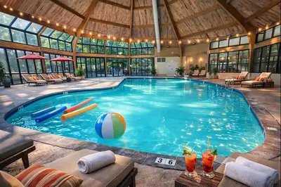 a large swimming pool in a large building at Modern 3BR Townhouse Near Kalahari, Aquatopia & Great Wolf in Tannersville
