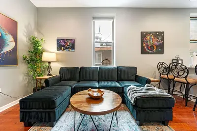 a living room with a couch and a table at Large 3 bdrm apt, 2ba, unique art in Philadelphia