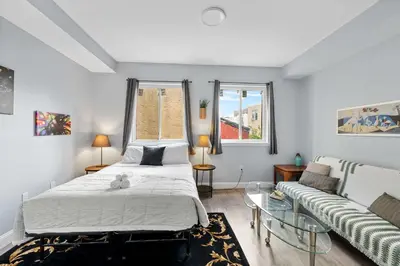 a bedroom with a bed and a couch at Brand New Dbl Unit Roofdeck Outdoor Patio in Philadelphia