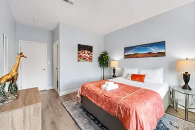 a bedroom with a bed and a giraffe on the wall at Brand New Dbl Unit Roofdeck Outdoor Patio in Philadelphia