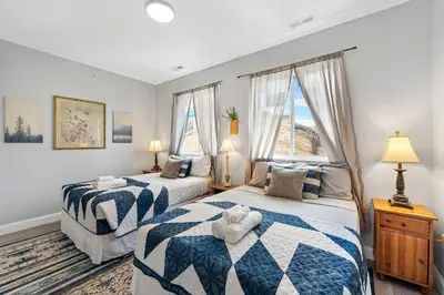 two beds in a room with two windows at Brand New Dbl Unit Roofdeck Outdoor Patio in Philadelphia