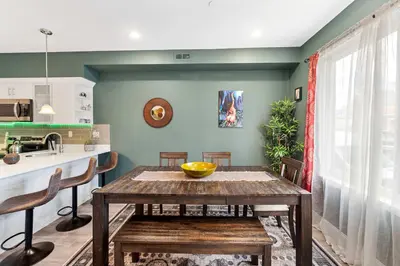 a kitchen with a wooden table and chairs in a room at Brand New Dbl Unit Roofdeck Outdoor Patio in Philadelphia