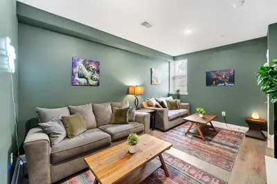 a living room with a couch and a table at Brand New Dbl Unit Roofdeck Outdoor Patio in Philadelphia