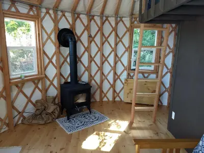 a room with a wood stove in a yurt at Livingston Manor YURT in Parksville