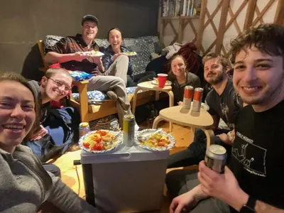 a group of people sitting in a room with food at Livingston Manor YURT in Parksville