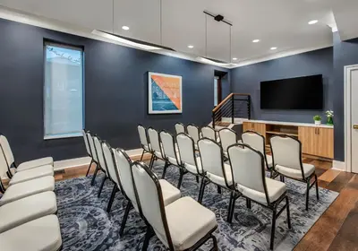 a conference room with chairs and a flat screen tv at Hyatt Place Newark-Main Street in Newark