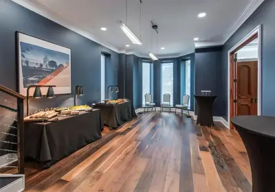 a dining room with tables and chairs and blue walls at Hyatt Place Newark-Main Street in Newark