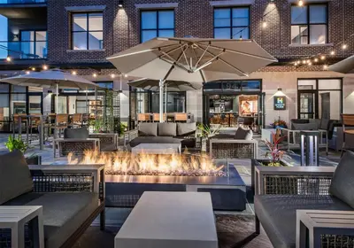 a restaurant with a fire pit in a building at Hyatt Place Newark-Main Street in Newark