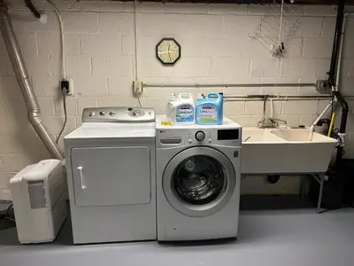 a washing machine and a sink in a laundry room at M2 Comfortable Room near Rutgers U, hospitals in New Brunswick
