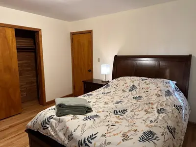 a bedroom with a bed with a wooden head board at M2 Comfortable Room near Rutgers U, hospitals in New Brunswick