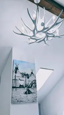 a chandelier hanging from a ceiling with a picture at Great Gorge-ous condo in Vernon Township