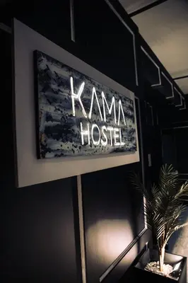 a sign for a karma house in a room with a plant at KAMA CENTRAL PARK in New York