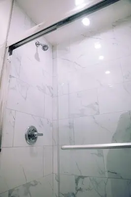 a shower with a glass door in a bathroom at KAMA CENTRAL PARK in New York