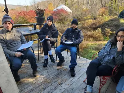 a group of people sitting on a bench at Catskills tiny house cabin in Livingston Manor