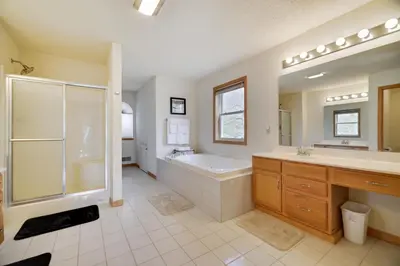 a large bathroom with a tub and a sink and a shower at Luxury Spacious Home with some FREE Amenities and Activities! in Mushroom Farms