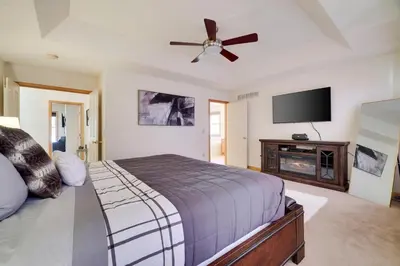 a bedroom with a bed and a flat screen tv at Luxury Spacious Home with some FREE Amenities and Activities! in Mushroom Farms